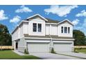 Two-story townhome with attached garage and modern exterior finishes at 2708 W North A St # 1, Tampa, FL 33609