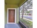 Screened-in porch with brown front door leading into the home at 2803 Santego Bay Ct, Brandon, FL 33511