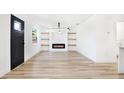 Light and airy living room with fireplace and wood-look floors at 2905 W Collins St, Tampa, FL 33607