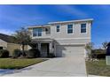 Two-story house with a two-car garage and nicely landscaped yard at 30755 Summer Sun Loop, Wesley Chapel, FL 33545