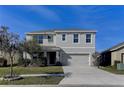 Two-story house with a two-car garage and a well-manicured lawn at 30755 Summer Sun Loop, Wesley Chapel, FL 33545