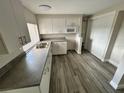 Modern kitchen with white cabinets and gray countertops at 3341 Wiltshire Dr, Holiday, FL 34691