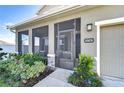 Attractive front entrance with screened door and landscaping at 35474 Quartz Lake Dr, Zephyrhills, FL 33541