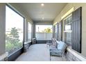 Relaxing screened porch with two light blue chairs and view of the backyard at 35474 Quartz Lake Dr, Zephyrhills, FL 33541