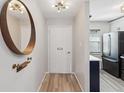 Bright and airy entryway with modern mirror and wood accent at 3717 Trophy Blvd, New Port Richey, FL 34655