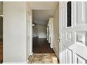 Front door entrance opening to a living area with hardwood floors at 37401 Wedgewood Dr, Zephyrhills, FL 33542