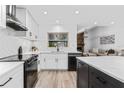 Modern kitchen with white cabinets, stainless steel appliances, and a herringbone backsplash at 3915 Briarlake Dr, Valrico, FL 33596