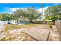 Large backyard with a screened patio and wooden fence at 4113 S Drexel Ave, Tampa, FL 33611