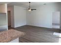 Spacious living room with wood-look flooring and ceiling fan at 4294 Danbury St, North Port, FL 34286