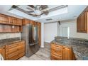 Kitchen featuring stainless steel appliances, wood cabinets and granite countertops at 435 Laughing Gull Ln, Palm Harbor, FL 34683