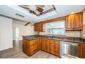 Well-lit kitchen featuring wood cabinets, granite countertops, and stainless steel appliances at 435 Laughing Gull Ln, Palm Harbor, FL 34683