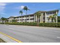 Exterior of a two-story building with palm trees and manicured hedges at 4455 Duhme Rd # 305, St Petersburg, FL 33708