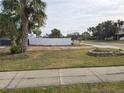 Vacant lot with a white fence and sidewalk at 4701 Lodestone Dr, Tampa, FL 33615