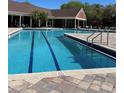 Community pool with lap lanes, lounge area, and brick pavers at 5557 Baywater Dr, Tampa, FL 33615