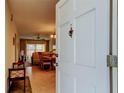 Open doorway view into living area with dining table and seating at 680 71St Ave # 14, St Pete Beach, FL 33706