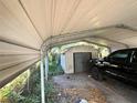 Carport with storage shed and space for a vehicle at 804 E 128Th Ave, Tampa, FL 33612