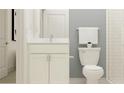 Bathroom with white vanity, toilet, and shower at 9728 Runaway Breeze Dr, Land O Lakes, FL 34637