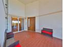 Bright and airy entryway with tiled floors and comfortable seating at 1030 Bellasol Way # 402, Apollo Beach, FL 33572