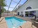 Relaxing screened-in pool area with lounge chairs and patio furniture at 11123 Elmhurst Dr, Pinellas Park, FL 33782