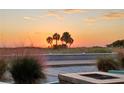 Peaceful beach sunset view with palm trees in the foreground at 11730 Gulf Blvd # 49, St Petersburg, FL 33706