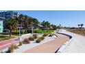 Beachfront walkway with palm trees, firepit, and shuffleboard at 11730 Gulf Blvd # 49, St Petersburg, FL 33706