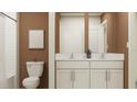 Double vanity bathroom with white cabinets and subway tile at 12223 Radiant Gem Trl, Parrish, FL 34219