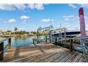 Wooden dock with boat lift on calm water at 129 Wall St, Redington Shores, FL 33708