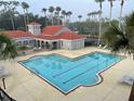 Community pool with a relaxing atmosphere and surrounding landscaping at 18001 Richmond Place Dr # 721, Tampa, FL 33647