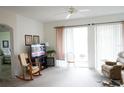 Relaxing living room featuring a rocking chair and access to a patio at 2182 Acadia Greens Dr # 66, Sun City Center, FL 33573