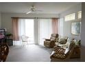 Bright living room with comfortable seating and sliding glass doors at 2182 Acadia Greens Dr # 66, Sun City Center, FL 33573