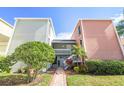 Exterior view of two-story condo building with brick pathway at 2424 W Tampa Bay Blvd # C212, Tampa, FL 33607