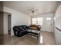 Living room with tiled floors, two sofas, and coffee table; access to other rooms at 2480 18Th N Ave, St Petersburg, FL 33713