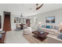 Bright living room with hardwood floors, stylish furniture, and access to dining area at 2552 Glenrise Pl, Wesley Chapel, FL 33544