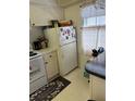 Cozy kitchen with white cabinets and appliances at 3115 Mission Grove Dr, Palm Harbor, FL 34684