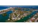 Aerial view of waterfront home with private dock and boat at 3118 S Maritana Dr, St Pete Beach, FL 33706