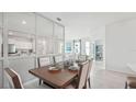 Open dining area with mirrored wall and view into living room at 32704 Rustic Rise Rd, San Antonio, FL 33576