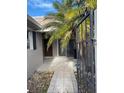 Front entry with walkway, palm tree, and gate at 439 Boca Ciega Point N Blvd, St Petersburg, FL 33708