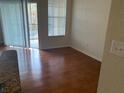 Living room with wood floors and sliding glass doors at 5125 Palm Springs Blvd # 10303, Tampa, FL 33647