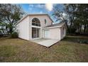 Back of house showing sliding glass doors and patio at 5147 Sterling Manor Dr, Tampa, FL 33647