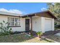 House exterior featuring a white stucco finish and a single-car garage at 7310 Oakshire Dr, Port Richey, FL 34668