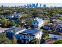 Aerial view showcasing a house with solar panels and city skyline in background at 818 W Adalee St, Tampa, FL 33603