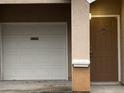 Townhome entry with attached garage and brown door at 10535 Villa View Cir # 10535, Tampa, FL 33647