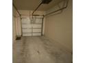 Empty attached garage with white door at 10535 Villa View Cir # 10535, Tampa, FL 33647