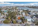 Aerial view of property and surrounding houses near beach at 128 Bay Plz, Treasure Island, FL 33706