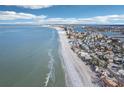 Aerial view of coastline, showing beach, ocean, and residential area at 128 Bay Plz, Treasure Island, FL 33706