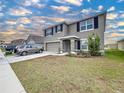 Two-story house exterior, featuring a two-car garage and well-maintained lawn at 16779 Sunburst Lake St, Wimauma, FL 33598