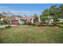 One-story home showcasing a well-manicured lawn and driveway at 1728 Allens Ridge N Dr, Palm Harbor, FL 34683