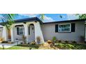 Newly renovated home with a neutral color palette, stylish garage door and well-manicured lawn at 1967 Coolidge Rd, Holiday, FL 34691