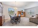 Combined dining and living room with wooden furniture and carpet at 19724 Post Island Loop, Land O Lakes, FL 34638