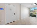 Bright condo entry with white door and tile floor at 301 Cordova Grn, Seminole, FL 33777
